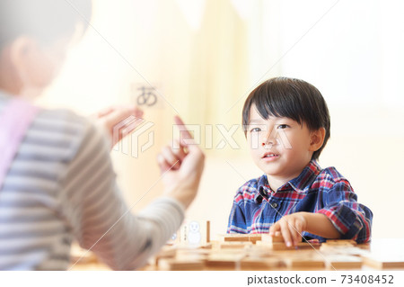 Little boy staring at a character block 73408452