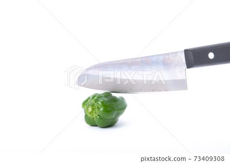 Pepper kitchen knife cut white background Pepper kitchen knife cut white background 73409308
