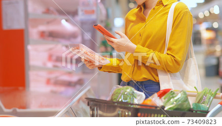 businesswoman scanning apple 73409823