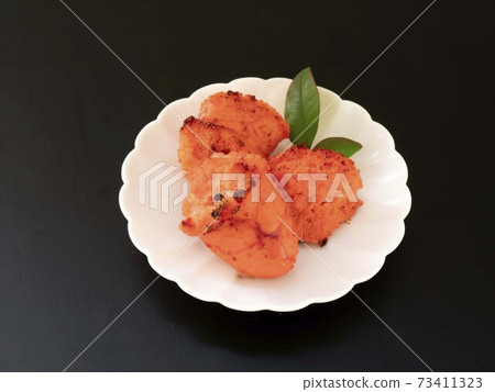 Grilled spicy cod roe served on a white plate 73411323