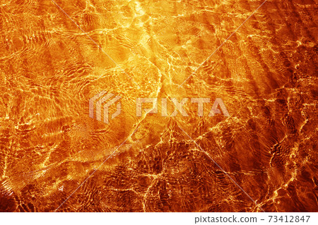 Photo background macro of transparent golden water 73412847