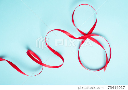 Red gift celebration ribbon in 8 digit shape. Happy woman's day 73414017