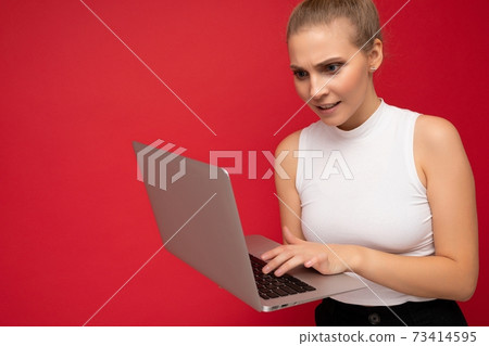Side profile photo shot of beautiful asking thoughtful blond young woman with gathered hair wearing 73414595