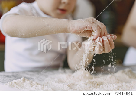 Little boy cook the dough for cookies Little boy cook the dough for cookies 73414941