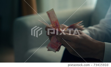Male hand counting banknotes 73415910