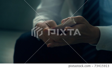 Male hand counting banknotes 73415913