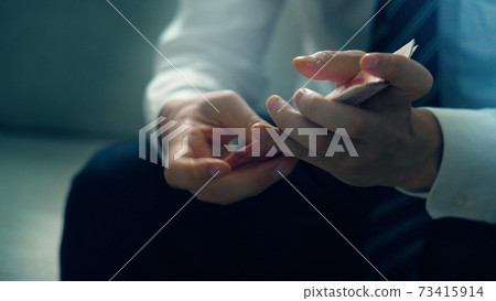 Male hand counting banknotes 73415914