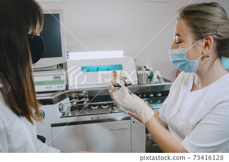 Otolaryngologist preparing for the medical examination procedure 73416128