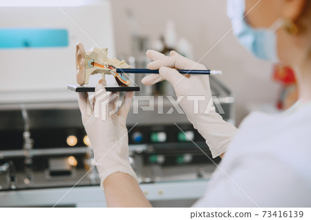 Otolaryngologist preparing for the medical examination procedure 73416139