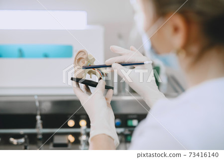 Otolaryngologist preparing for the medical examination procedure 73416140