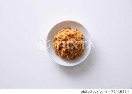 Miso in a small plate, white background 73416324