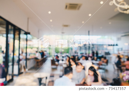 Abstract blurred crowd of people drinkking coffee in cafe Abstract blurred crowd of people drinkking coffee in cafe 73417357