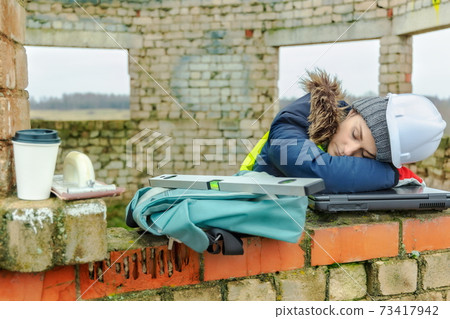 Tired woman civil engineer sleeping in work time Tired woman civil engineer sleeping in work time 73417942