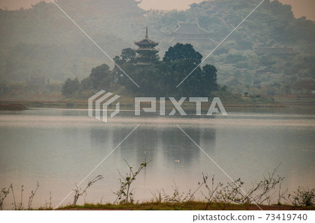 Cinematic scenery of Hoa Lu Ancient Capital covered in the morning mist in Ninh Binh, Vietnam 73419740
