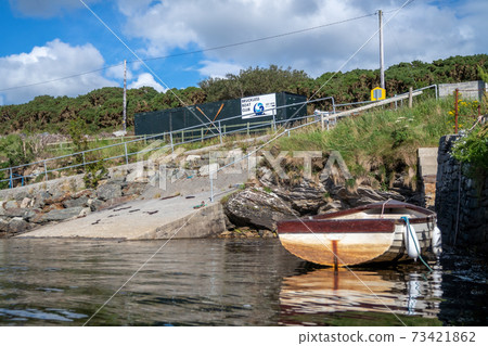 Rowing boat at the pier in Bruckless in County Donegal - Ireland. Rowing boat at the pier in Bruckless in County Donegal - Ireland. 73421862