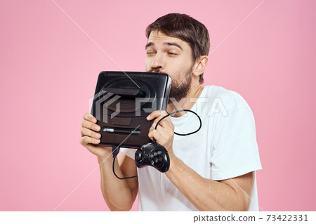 Man with prefix in hand joystick games lifestyle fun pink background white t-shirt 73422331