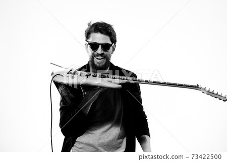 man with guitar in hands musician rock star performance lifestyle light background 73422500