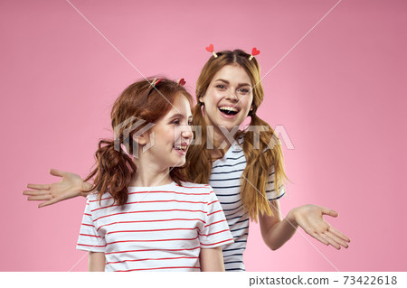 Cheerful mom and daughter joy lifestyle studio pink background family 73422618