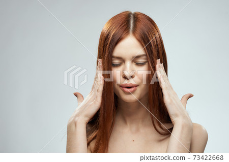 beautiful red-haired woman naked shoulders cosmetics long hair glamor light background beautiful red-haired woman naked shoulders cosmetics long hair glamor light background 73422668