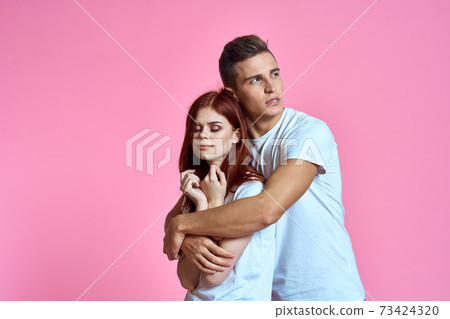 lovers man and woman in jeans and t-shirt on pink background cropped view family romance teenagers lovers man and woman in jeans and t-shirt on pink background cropped view family romance teenagers 73424320