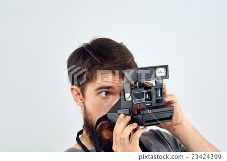 male photographer holding camera professional lens creative studio work light background male photographer holding camera professional lens creative studio work light background 73424399