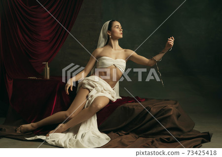 Modern remake of classical artwork with coronavirus theme - young medieval woman on dark background Modern remake of classical artwork with coronavirus theme - young medieval woman on dark background 73425418