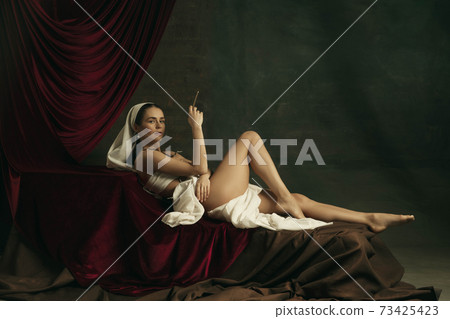 Modern remake of classical artwork with coronavirus theme - young medieval woman on dark background Modern remake of classical artwork with coronavirus theme - young medieval woman on dark background 73425423