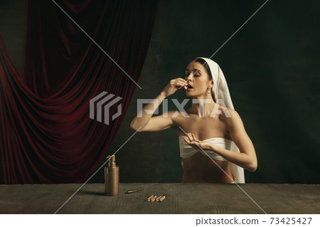 Modern remake of classical artwork with coronavirus theme - young medieval woman on dark background Modern remake of classical artwork with coronavirus theme - young medieval woman on dark background 73425427