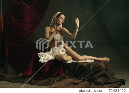 Modern remake of classical artwork with coronavirus theme - young medieval woman on dark background Modern remake of classical artwork with coronavirus theme - young medieval woman on dark background 73425432
