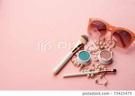 eyeshadow accessories beads makeup brushes collection professional cosmetics on pink background eyeshadow accessories beads makeup brushes collection professional cosmetics on pink background 73425475