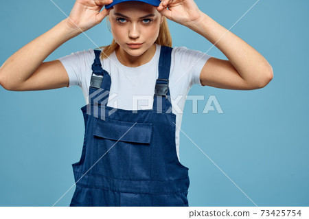 Woman in work uniform blue cap carriage delivery service courier blue background 73425754
