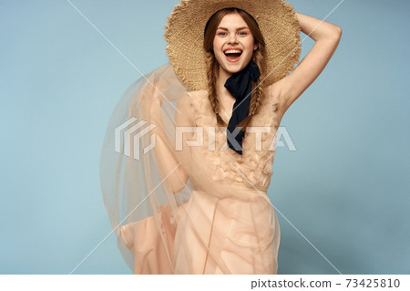 Girl in a pink dress on a blue background gestures with her hands romance model fun emotions cropped view 73425810