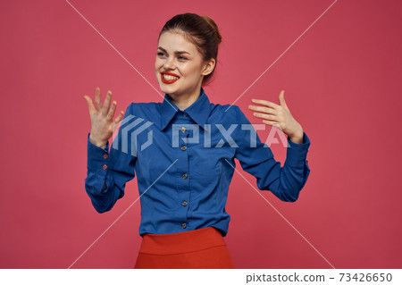 fashionable woman in blue shirt on pink background Red skirt emotions model gesturing with hands cropped view Copy Space fashionable woman in blue shirt on pink background Red skirt emotions model gesturing with hands cropped view Copy Space 73426650