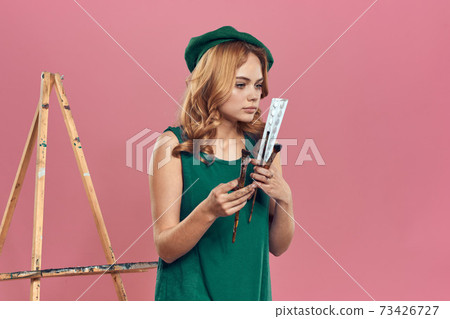 Woman artist green beret watercolor brush drawing art paint lifestyle hobby pink background 73426727