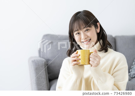 Young woman with a mug Young woman with a mug 73426980
