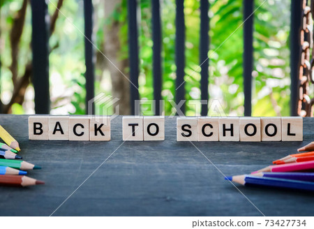 Word tiles the word " back to school " Text dice cube concept / Letter and Color pencils isolated on wooden black background. Block of alphabet studded on the floor. colorful. Word tiles the word " back to school " Text dice cube concept / Letter and Color pencils isolated on wooden black background. Block of alphabet studded on the floor. colorful. 73427734