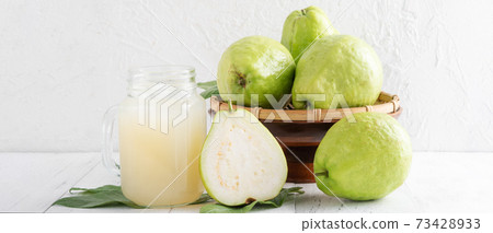 Guava juice guava wood background beverage fruit cold drink drink dieting glass fresh fruit milkshake healthy fresh tropical Guava juice guava wood background beverage fruit cold drink drink dieting glass fresh fruit milkshake healthy fresh tropical 73428933