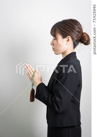 一個年輕的女人在葬禮上攜手共進 73428940