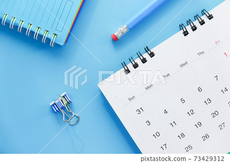 deadline concept with stack of calendar and pencil on color background  73429312
