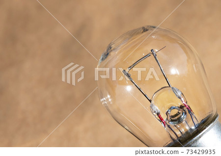 Old car envelope incandescent lamp. Close-up of filament Old car envelope incandescent lamp. Close-up of filament 73429935