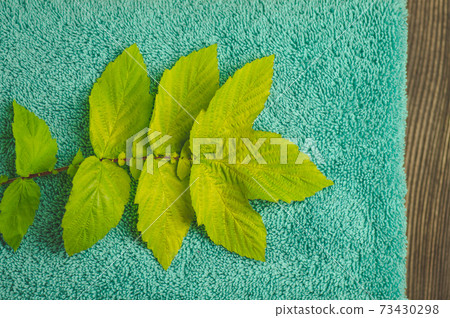 Mint colored towel on dark background texture Mint colored towel on dark background texture 73430298