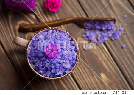 Concept of spa treatment with violet salt 73430301