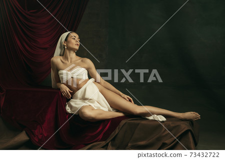 Modern remake of classical artwork with coronavirus theme - young medieval woman on dark background 73432722