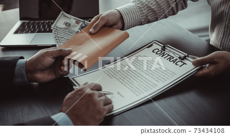 Businessmen give dollars to bribe employees in signing contracts to buy illegal land and real estate, Business fraud and social injustice, corruption and bribery concept. Businessmen give dollars to bribe employees in signing contracts to buy illegal land and real estate, Business fraud and social injustice, corruption and bribery concept. 73434108