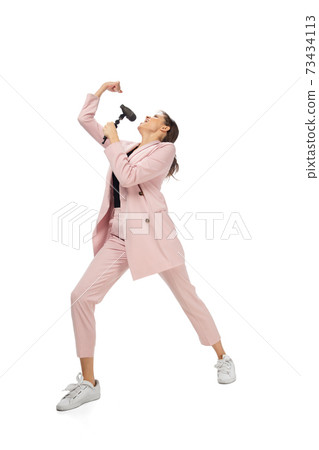 Happy young woman dancing in stylish clothes or suit, remaking legendary moves of celebrity from culture history 73434113