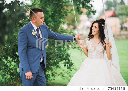 Gorgeous happy couple standing close to each other and looking in eyes Gorgeous happy couple standing close to each other and looking in eyes 73434116
