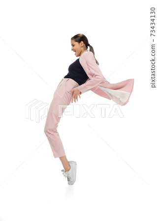 Happy young woman dancing in stylish clothes or suit, remaking legendary moves of celebrity from culture history Happy young woman dancing in stylish clothes or suit, remaking legendary moves of celebrity from culture history 73434130