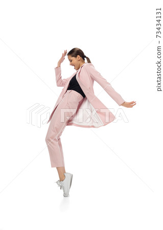 Happy young woman dancing in stylish clothes or suit, remaking legendary moves of celebrity from culture history Happy young woman dancing in stylish clothes or suit, remaking legendary moves of celebrity from culture history 73434131