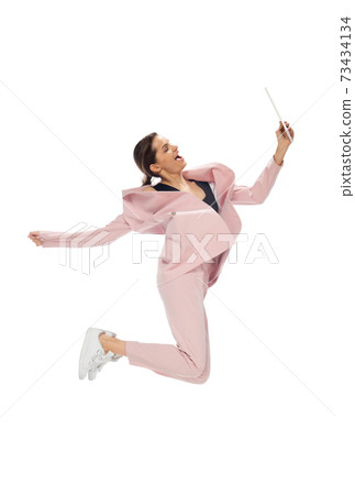 Happy young woman dancing in stylish clothes or suit, remaking legendary moves of celebrity from culture history Happy young woman dancing in stylish clothes or suit, remaking legendary moves of celebrity from culture history 73434134