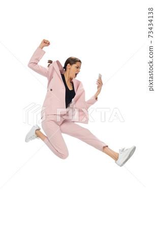 Happy young woman dancing in stylish clothes or suit, remaking legendary moves of celebrity from culture history Happy young woman dancing in stylish clothes or suit, remaking legendary moves of celebrity from culture history 73434138